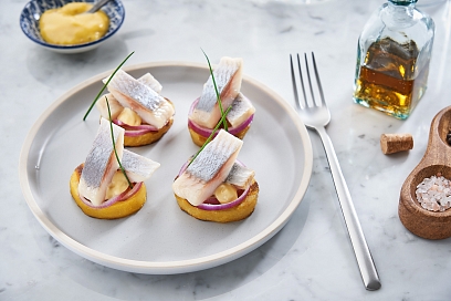Herring served on potato with mustard sauce